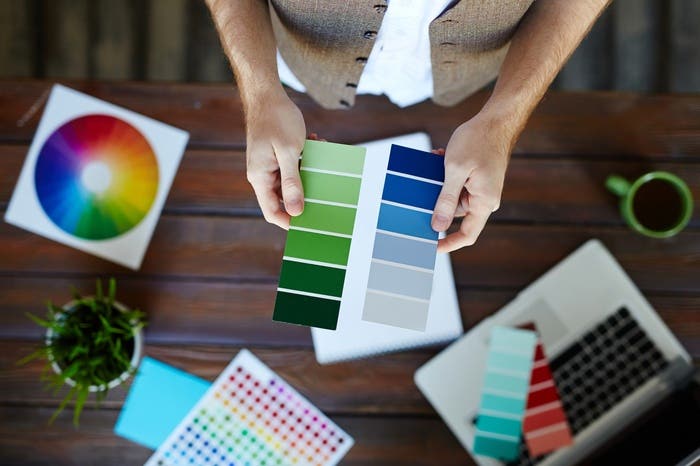 man holding color gradient papers